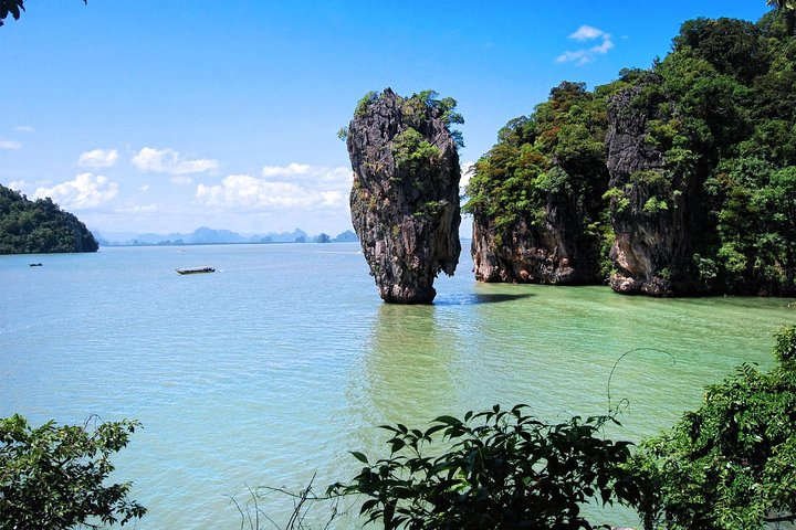 Experience serene waters and stunning limestone formations on a longtail boat journey to James Bond Island discovering hidden gems like Wat Suwan Kuha Temple and Panyee floating village.