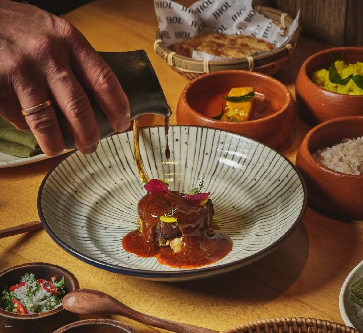 Savor the essence of coastal India at JHOL where each dish celebrates bold flavors and fresh ingredients perfect for sharing amongst friends in Bangkok's inviting setting.