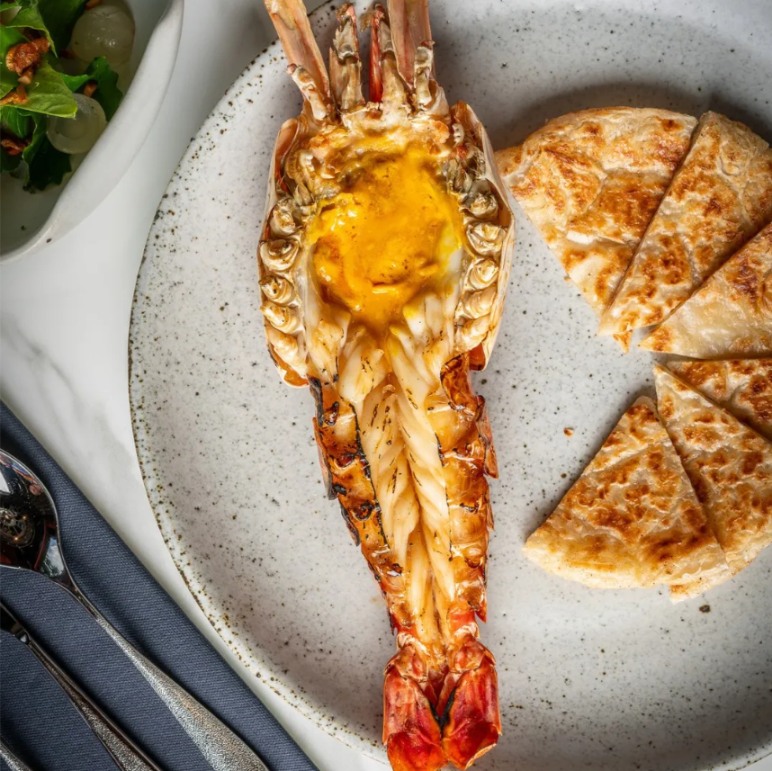 Experience a culinary journey at Jim Thompson where local flavors meet innovative twists all set against the backdrop of traditional Thai architecture and lush gardens. Indulge in authentic dishes that celebrate rich heritage.