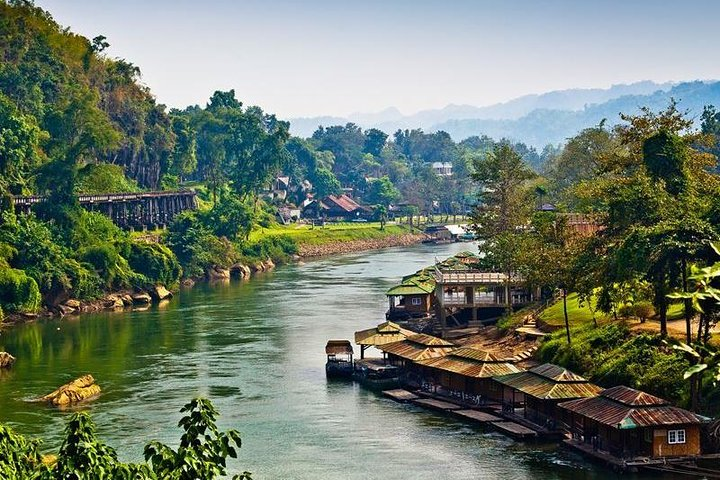 Explore the stunning landscapes of Kanchanaburi where lush greenery meets the serene River Kwai inviting travelers to uncover rich history while enjoying a delightful private lunch with an informative guide.