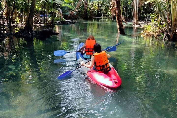 Glide through the tranquil waters of Klong Namsai surrounded by lush mangroves and limestone cliffs creating unforgettable memories while exploring Krabi’s stunning natural beauty.