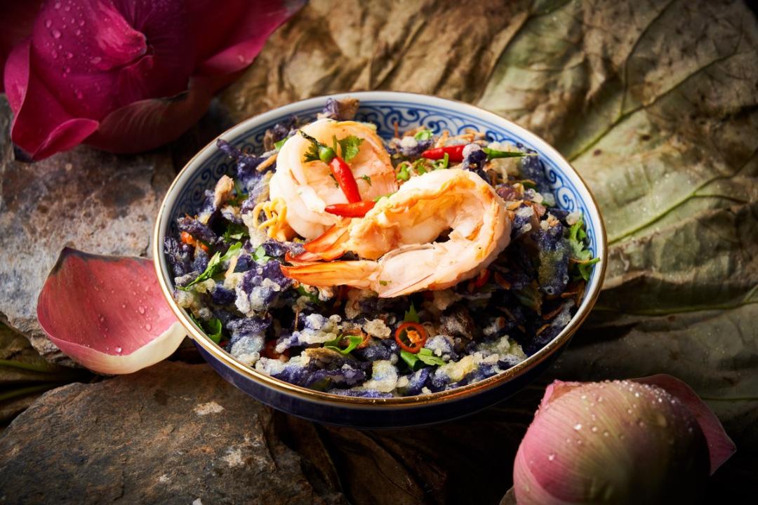Delve into authentic Thai flavors with beautifully presented dishes that celebrate fresh ingredients such as shrimp served over fragrant rice inviting travelers to savor each bite.