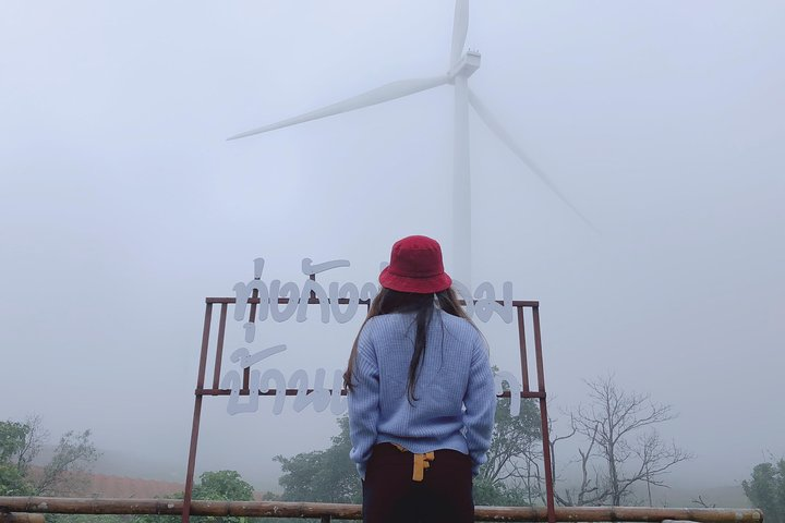 Experience the serene beauty of Khao Kho's misty landscapes where wind turbines rise above the fog and create a perfect backdrop for unforgettable memories. Explore nature’s wonders and local charm.