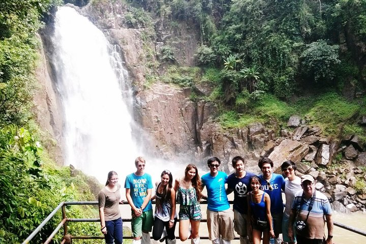 Experience the stunning Haew Narok Waterfall surrounded by lush greenery where travelers gather to share unforgettable moments while trekking through Khao Yai National Park's natural beauty.