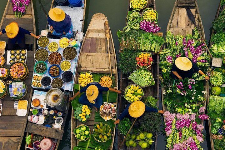 Explore the charm of local life at Khlong Lat Mayom & Taling Chan where colorful boats brim with Thai delicacies and fresh produce offering a delightful culinary adventure along the canals.