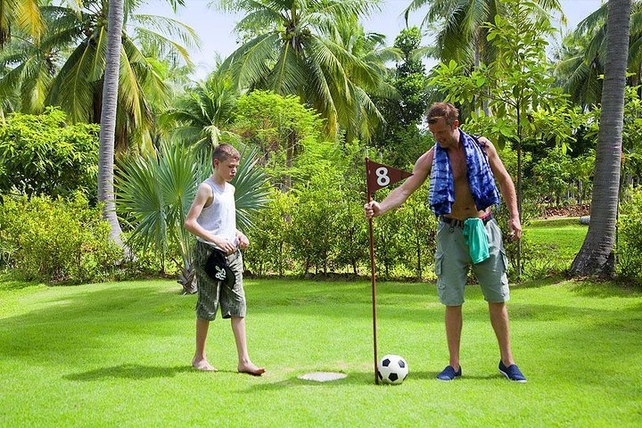 Experience the joy of footgolf amid lush greenery and tropical plants where friendly competition meets relaxation in a stunning jungle setting. Perfect for family and friends alike.
