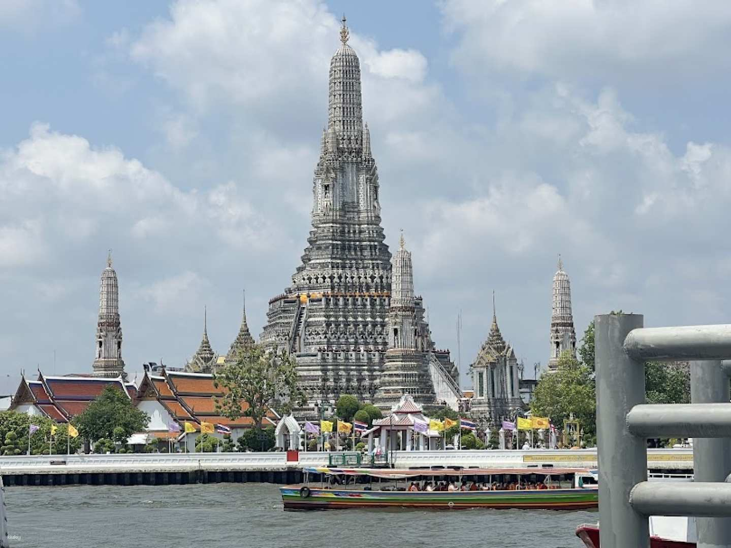 Explore Bangkok's local life while cruising the Chao Phraya River taking in the stunning Wat Arun and the majestic Grand Palace with their intricate architecture and rich history.