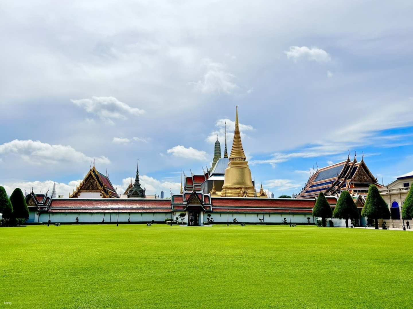Witness the stunning architecture of Wat Phra Kaew amidst lush greenery where history and artistry unite offering a serene escape in the heart of Bangkok's vibrant culture.