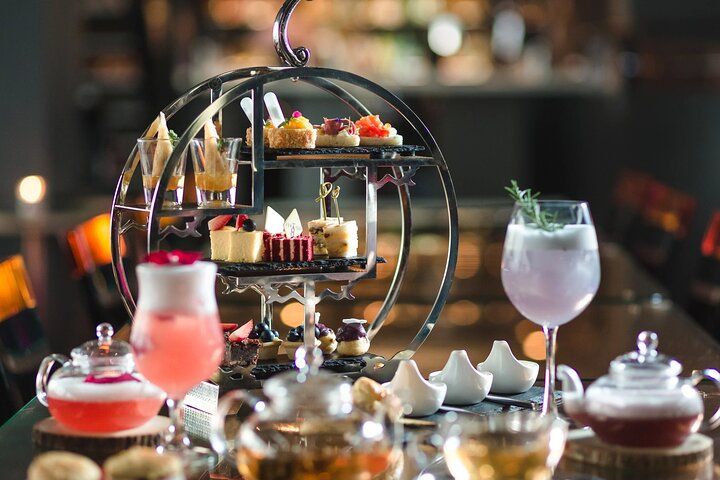 Savor the elegance of afternoon tea at Banyan Tree Bangkok featuring stunning skyline views and a delightful menu of savory and sweet treats perfect for a relaxing getaway.