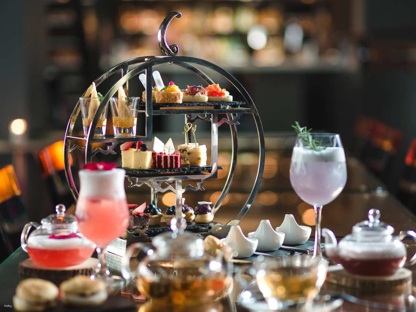 Savor the delight of afternoon tea at Banyan Tree Bangkok featuring exquisite treats and stunning city views perfect for a relaxed social gathering with friends.