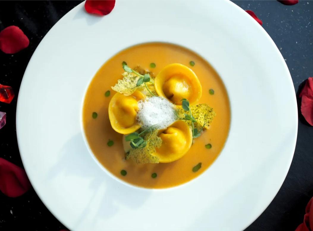 Indulge in exquisite Italian cuisine complemented by breathtaking skyline views making every meal a delightful journey through flavors and presentation at Medinii Panorama Restaurant.