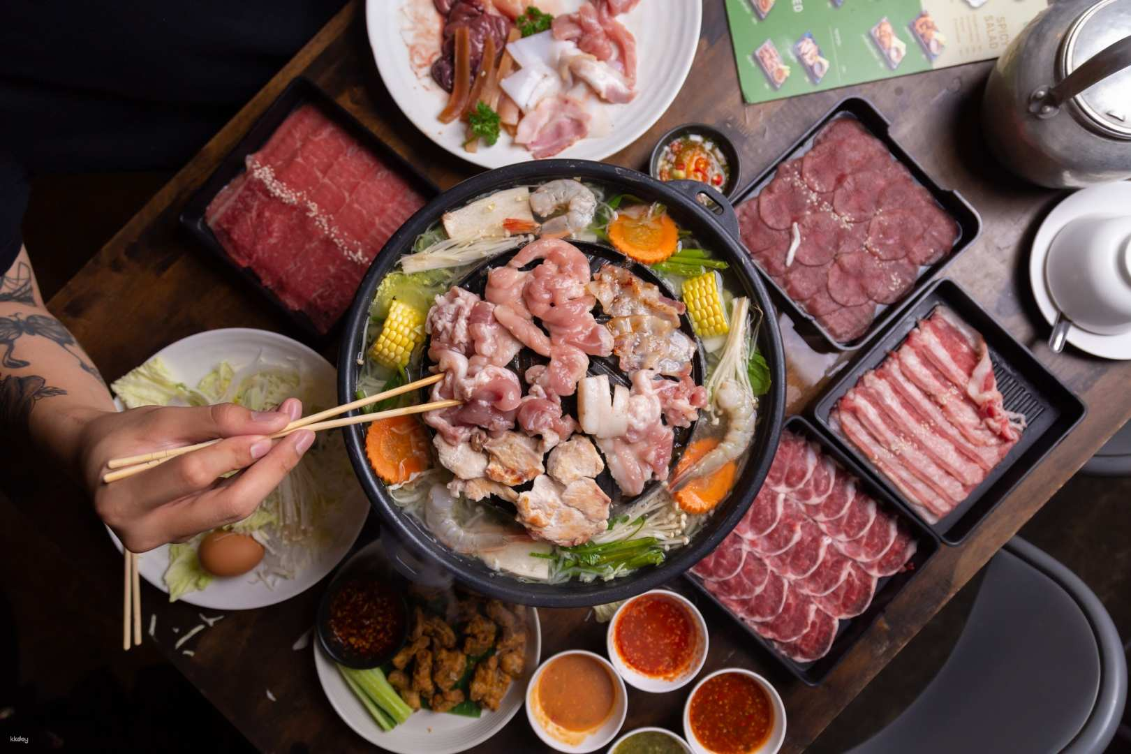 Savor the unique experience of grilling meats and seafood on a dome grill enjoying fresh ingredients and delightful broth perfect for culinary explorers in Bangkok.