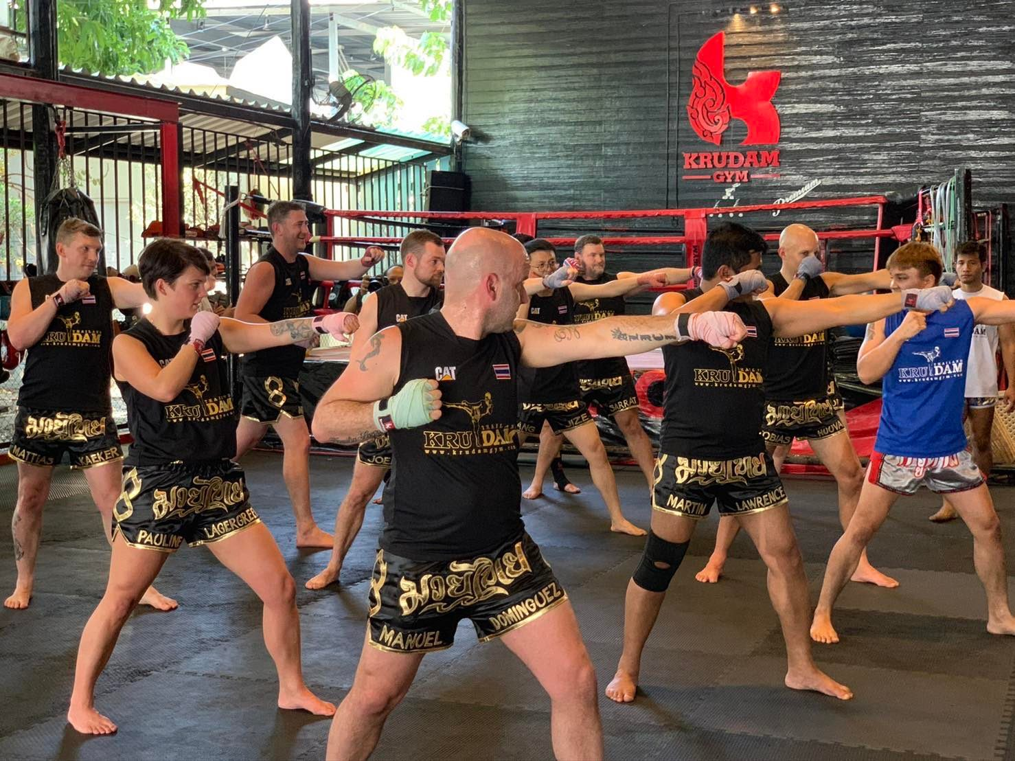 Engage in an immersive Muay Thai experience at Kru Dam Gym where diverse participants unite to master techniques enhance fitness and embody the spirit of this traditional martial art in Bangkok.