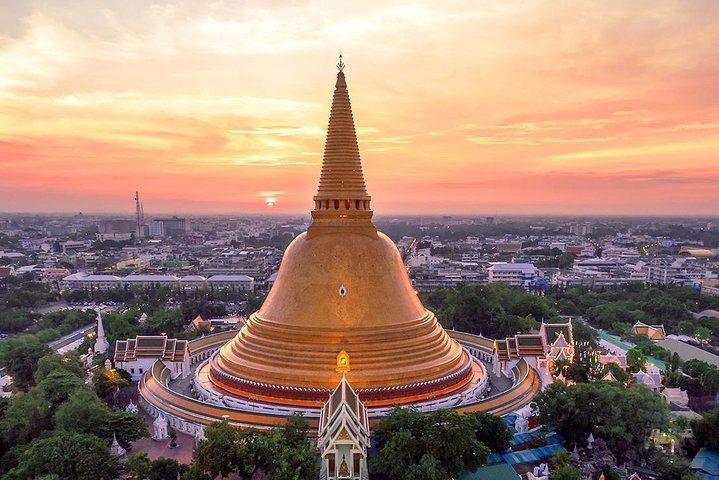 Breathtaking views of Phra Pathom Chedi illuminate the skyline inviting travelers to explore the rich history and culture of Nakhon Pathom with its stunning temples and picturesque landscapes.