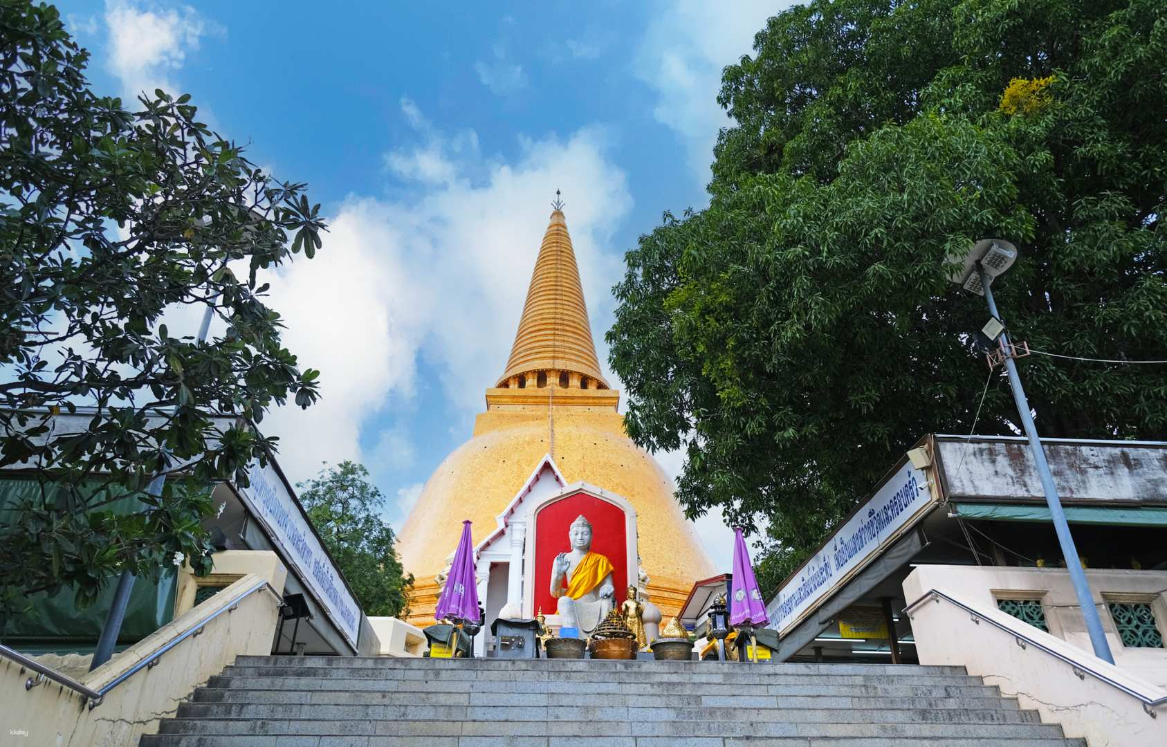 The stunning Wat Phra Pathom Chedi rises majestically inviting travelers to explore its serene beauty and historic significance. Discover the rich culture of Thailand at this remarkable site.