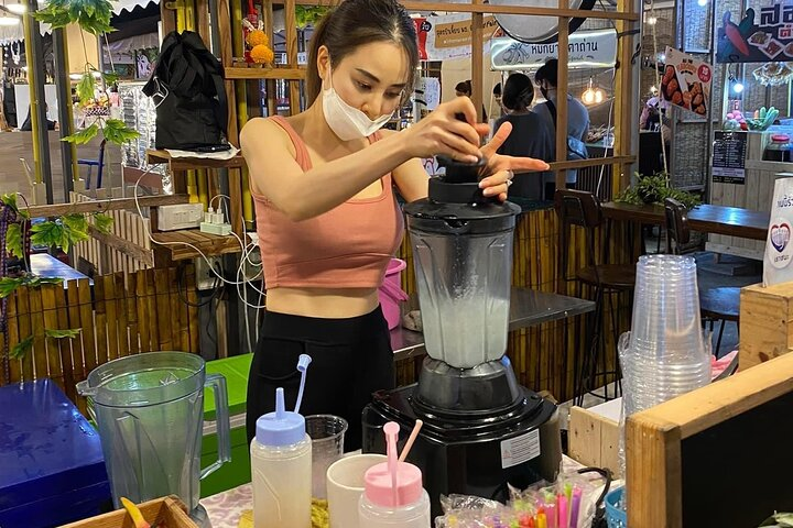 Experience the energy of Bangkok's Jodd Fairs Train Night Market where local delicacies are crafted fresh creating a delightful culinary adventure under the night sky.