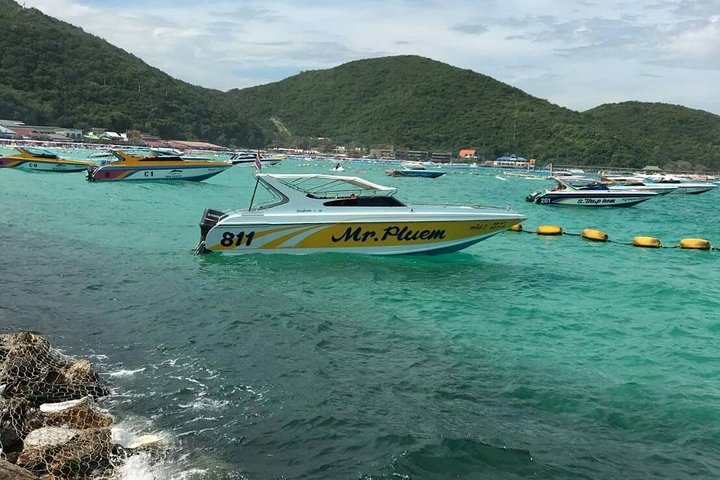 Dive into the serene waters of Coral Island where speedboats glide across turquoise waves inviting travelers to unwind on soft sandy shores and enjoy exciting beach activities.