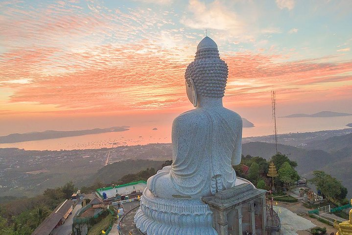 Witness stunning views from the Big Buddha as golden hues illuminate the sky offering a serene backdrop for reflection and exploration of Phuket’s rich culture and breathtaking landscapes.