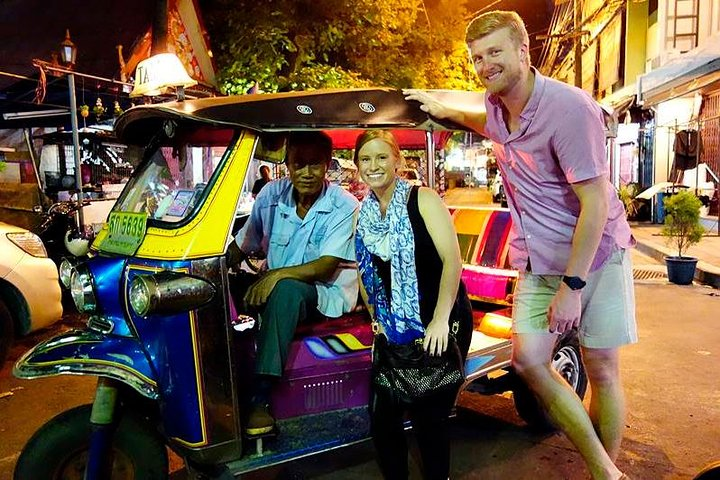 Experience the charm of Bangkok at night cruising through illuminated streets in a Tuk Tuk soaking in the city's rich culture while savoring snacks and cold drinks.
