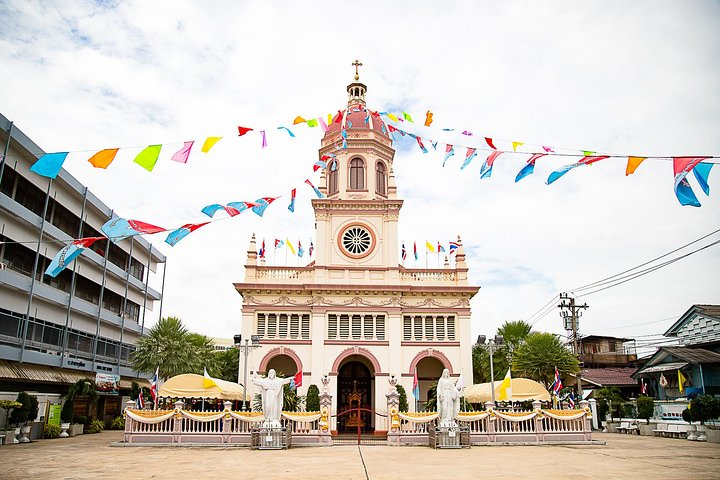 Experience the charm of Bangkok's historic communities with colorful flags fluttering against a backdrop of diverse architecture revealing the serene life along the Chao Phraya River.