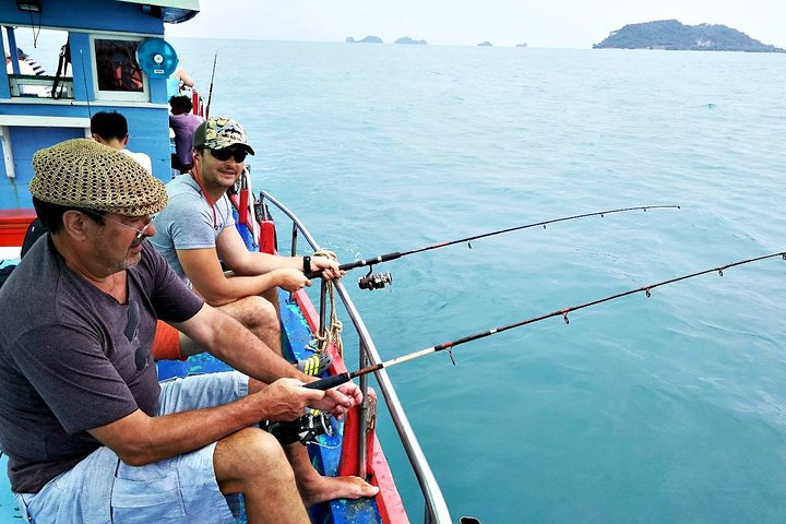 Experience the tranquility of fishing amidst stunning island scenery surrounded by crystal-clear waters and vibrant marine life while enjoying a leisurely day on a private boat.
