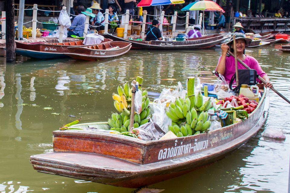 Discover the charm of Amphawa Floating Market as you glide through lush waterways savoring delicious street food and unique crafts with friendly vendors aboard colorful long-tail boats.