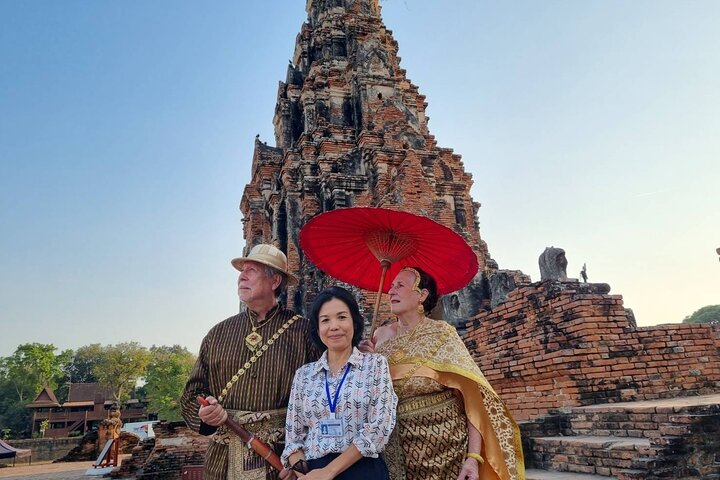 Explore the rich history of Ayutthaya while engaging with locals at the floating market discovering unique cultural experiences among ancient ruins and traditional attire.