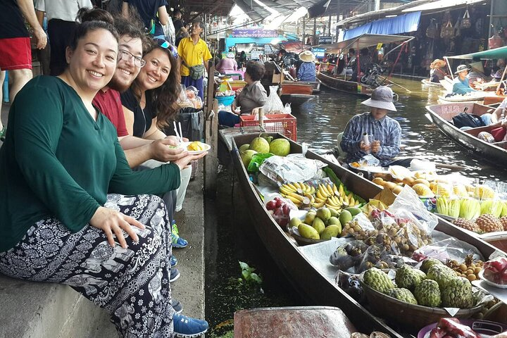 Immerse yourself in the local culture as you savor delicious Thai dishes while enjoying a leisurely boat ride amidst bustling markets surrounded by the rich flavors of Thailand.