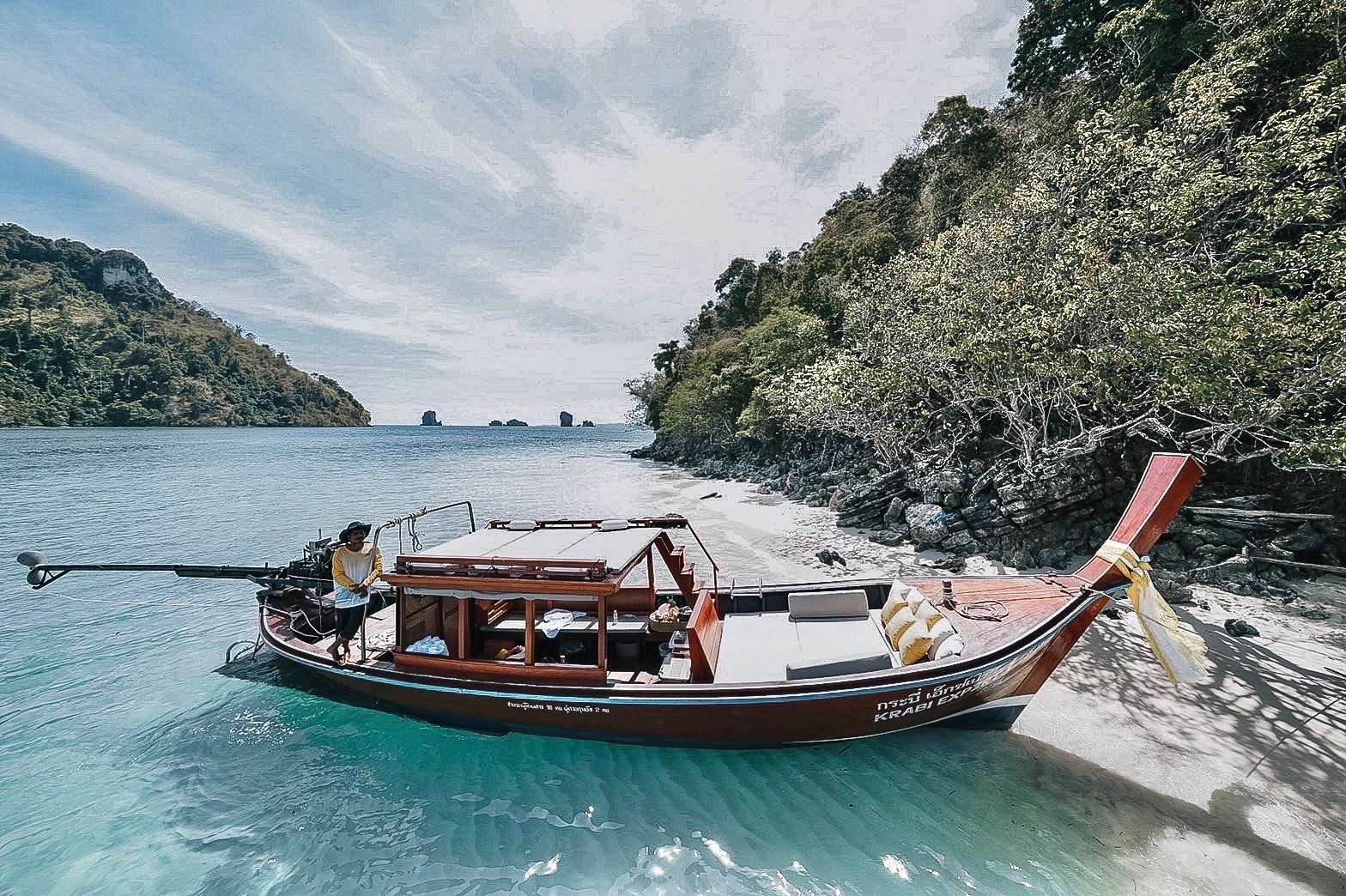 Sail through crystal-clear waters aboard a luxurious long-tail boat discovering hidden coves and pristine beaches offering an unforgettable escape in the beautiful region of Krabi.