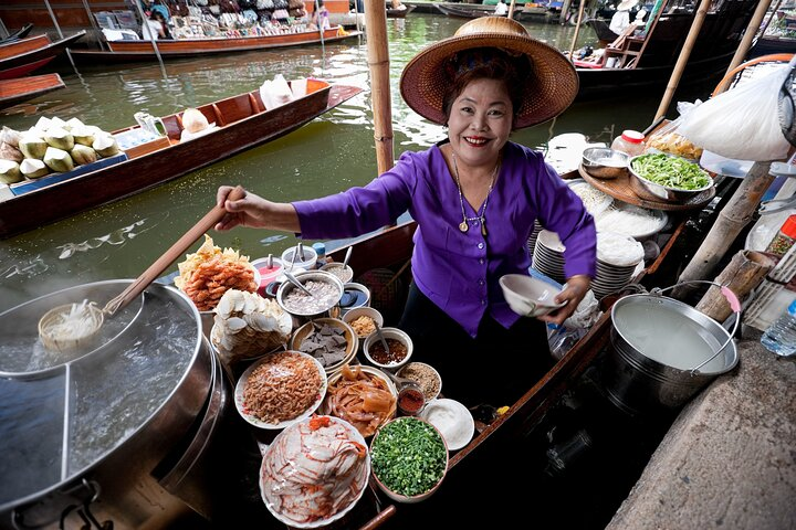 Experience the unique charm of Bangkok’s floating market where friendly vendors offer delicious street food and handmade crafts all set against the picturesque backdrop of traditional wooden boats.
