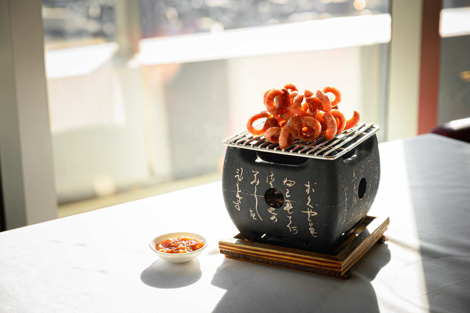 Indulge in a culinary adventure with expertly grilled delights complemented by panoramic views of Bangkok’s skyline perfect for socializing and savoring every moment at Red Sky Rooftop & Bar.