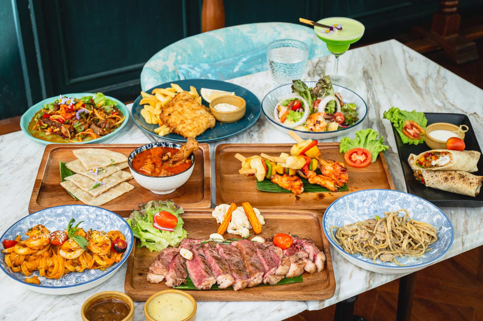 Indulge in authentic Thai cuisine while enjoying live jazz amidst lush greenery. Perfectly crafted cocktails complement a diverse menu all served with warm hospitality in a chic setting.