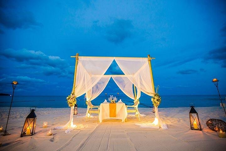 Experience a romantic dinner on the beach with gentle waves and a stunning view of the Gulf as you savor exquisite dishes in your private gazebo under the moonlight.