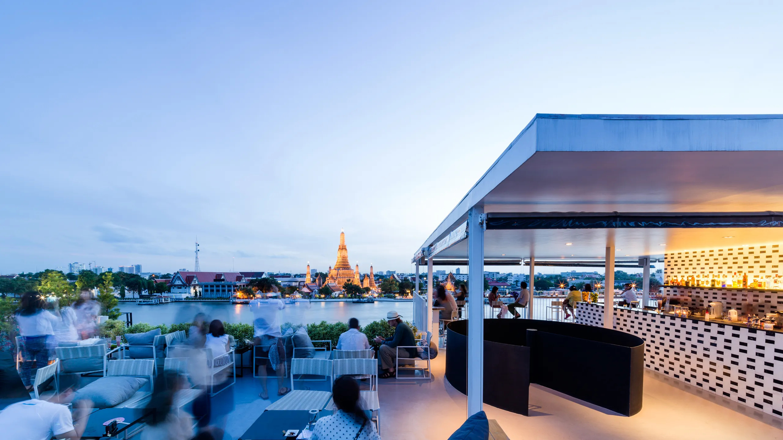 Savor exquisite drinks and delectable snacks while enjoying stunning views of the Chao Phraya River and Wat Arun perfect for a romantic dining experience in Bangkok.