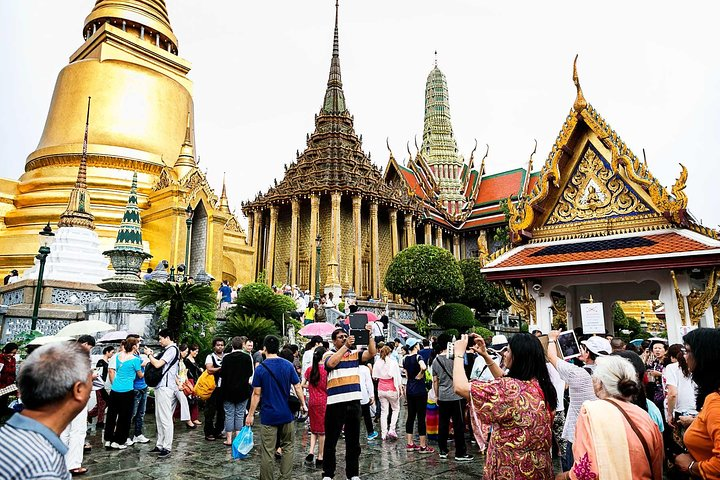 Immerse yourself in the charm of Bangkok exploring iconic landmarks like Wat Pho and the Golden Buddha while navigating lively streets filled with history and culture under the Thai sun.