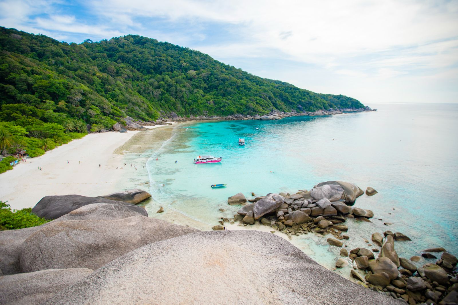 Pristine beaches meet clear turquoise waters inviting travelers to explore coral reefs and relax under the sun. A perfect day of snorkeling and scenic beauty awaits in the Similan Islands.