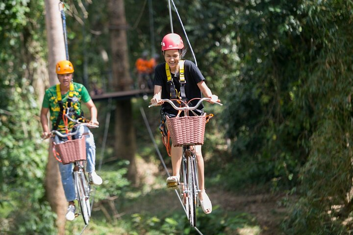 Soar through the rainforest on a Sky Bicycle surrounded by ancient trees and lush wildlife while enjoying breathtaking views of Koh Samui's tropical landscape from above.