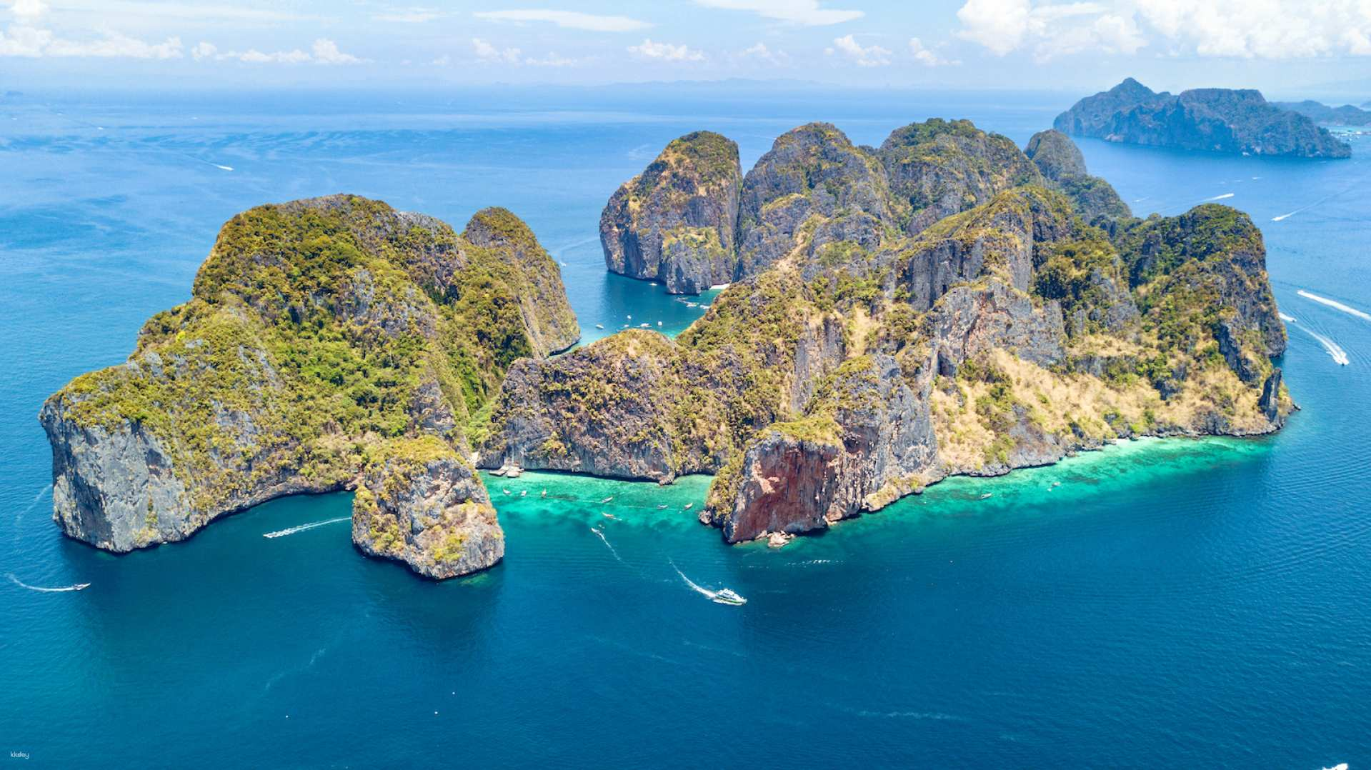Experience the allure of Phi Phi Islands where crystal-clear waters meet stunning rock formations inviting you to swim snorkel and soak up the sun on pristine beaches.