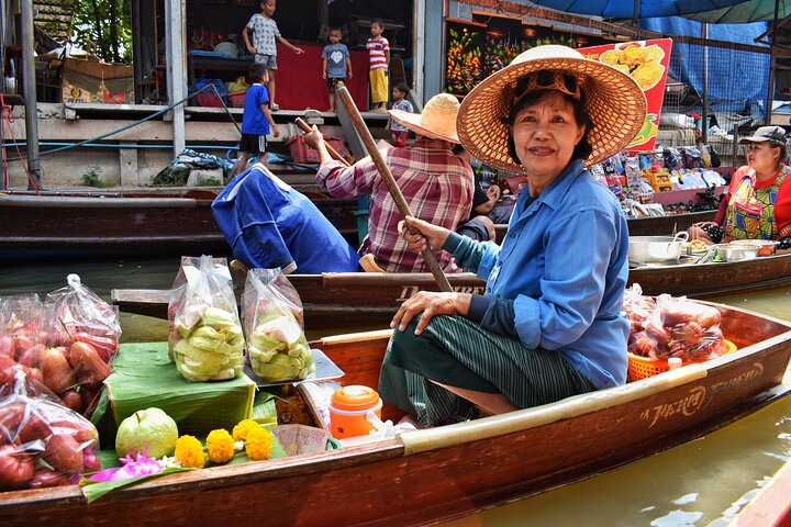 Explore the charm of Samut Song Kram's floating market where local vendors offer fresh produce from their boats surrounded by the lively sounds of daily market life.
