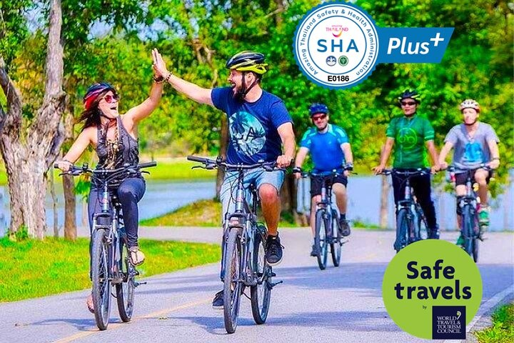 Explore Koh Kret's scenic paths on a bicycle sharing joyful moments with friends while embracing the local culture and breathtaking surroundings. Perfect for an unforgettable day of adventure!