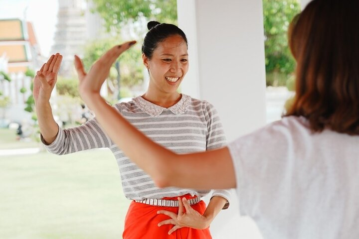 Immerse yourself in traditional Thai dance at Wat Arun learning graceful movements while savoring delicious snacks and refreshing drinks all under the serene backdrop of Bangkok's iconic temple.