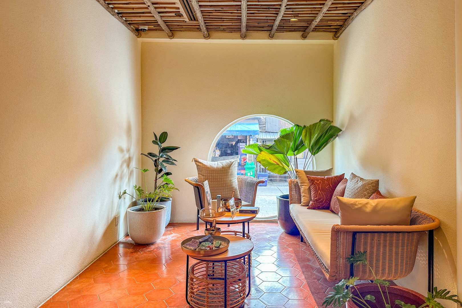 Experience tranquility at The Fig Lobby's spa where comfortable seating and greenery invite you to unwind. Enjoy a soothing massage from expert technicians in a serene setting.