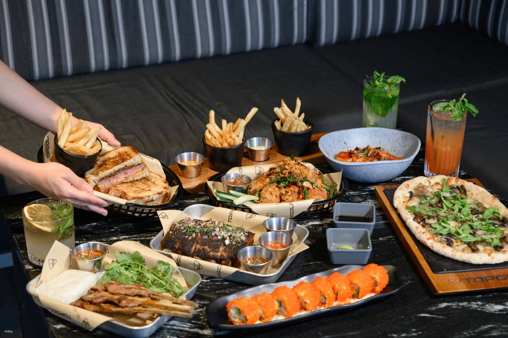 Savor delicious comfort food while enjoying the excitement of live sports on colossal screens at Topgolf Megacity Sports Bar Bangkok's go-to destination for fun and relaxation.