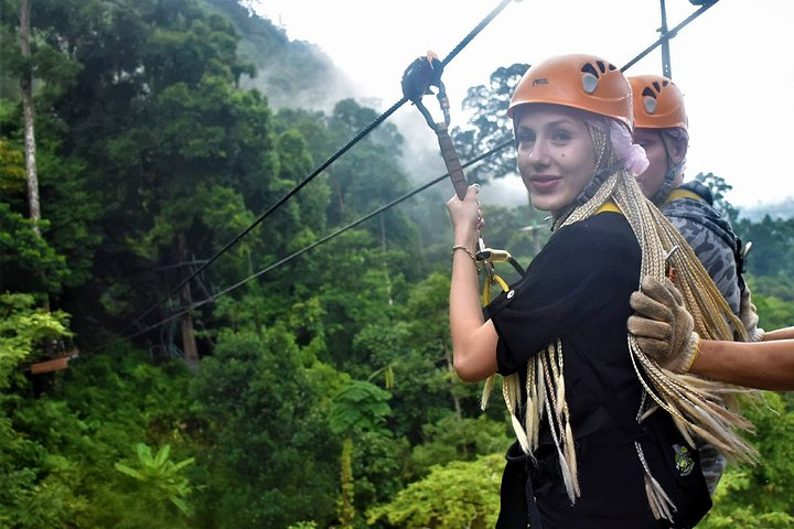 Fly through lush greenery on a remarkable zipline taking in breathtaking views of the jungle and waterfall all while enjoying a cozy café experience high above the ground.
