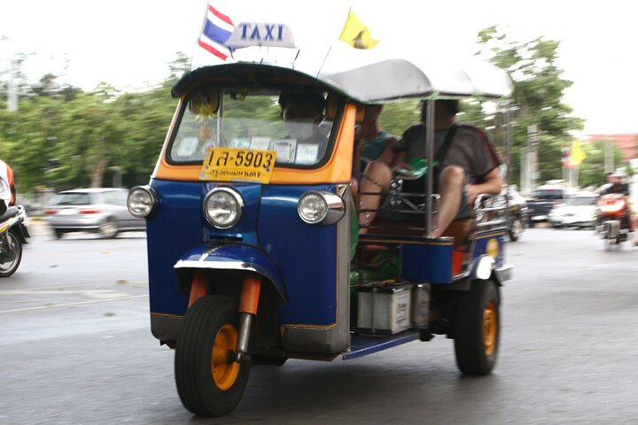 Explore Bangkok's Old Town in a Tuk Tuk enjoying local insights and stunning views of historic temples and the Chao Phraya River for an unforgettable travel adventure.