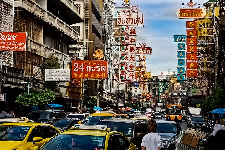 Experience the bustling streets of Chinatown adorned with neon signs and lively vendors as you savor mouthwatering street food in an unforgettable Tuk Tuk adventure through Bangkok.