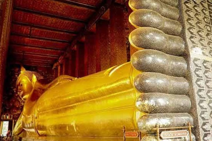 Experience the grandeur of Wat Pho's Reclining Buddha an impressive blend of artistry and spirituality inviting travelers to immerse themselves in Bangkok's rich history and cultural tapestry.