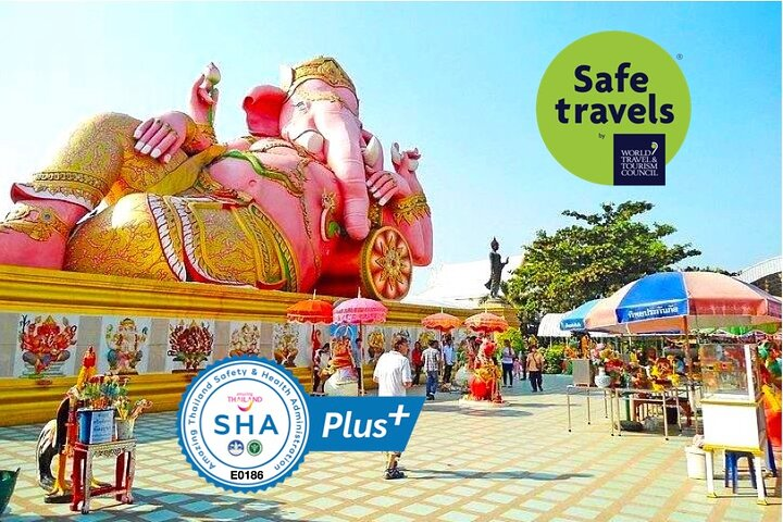 Experience serene views of the mighty Ganesha and unique architecture while savoring authentic local cuisine amidst a tranquil riverside setting ideal for relaxation and exploration.