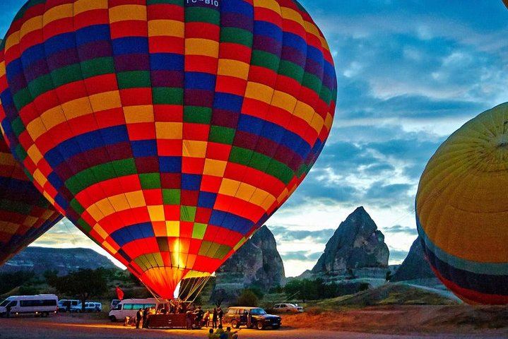 Experience the magic of Cappadocia as colorful hot air balloons rise against a stunning landscape offering a unique journey through the skies like no other destination can.