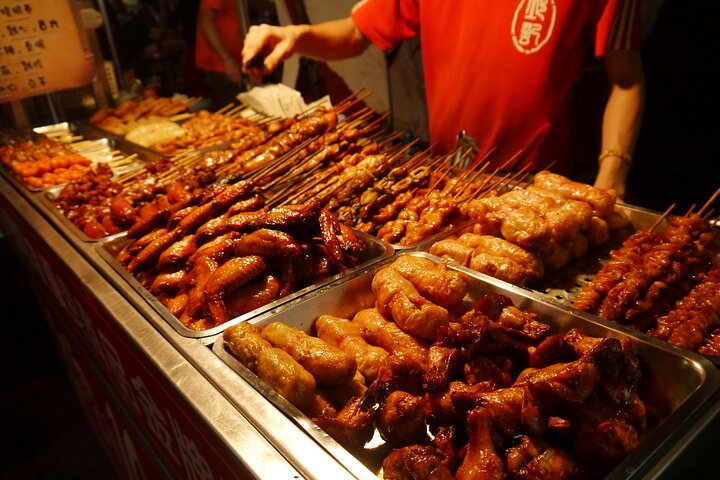 Explore the enticing world of Taiwanese street food savoring grilled delights and local specialties at Ningxia Night Market. It's a culinary adventure that captures the essence of Taipei!